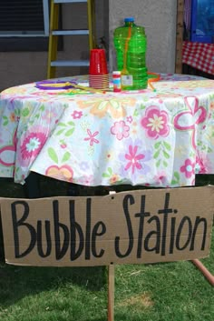 a table with a sign that says bubble station