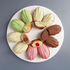 a white plate topped with assorted pastries on top of a gray countertop