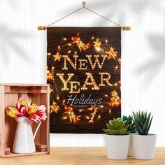 a wooden sign that says new year holidays with flowers and potted plants in front of it