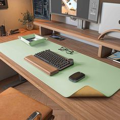 a computer desk with a keyboard, mouse and monitor on it in front of a flat screen tv