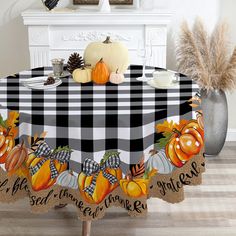 a black and white checkered table cloth with pumpkins on it