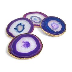 three pieces of purple and white agate with gold edges