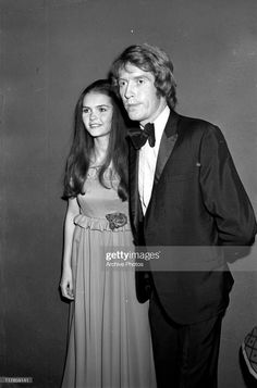 an old black and white photo of two people in formal wear posing for the camera