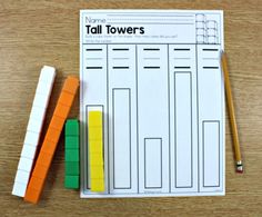 two pencils and some colored blocks on a table with a paper that says tall towers