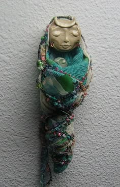 a small statue is hanging on the wall