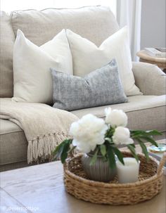 a living room filled with furniture and white flowers