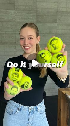 a woman holding tennis balls with faces drawn on them and the words do it yourself