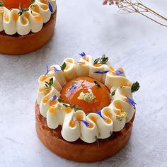 two small cakes with icing and flowers on them