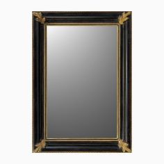 an antique black and gold framed mirror