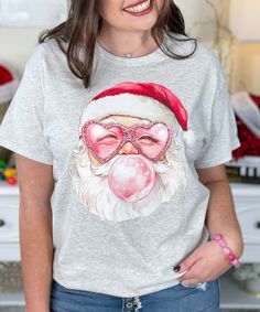 The Vintage Santa With Sunglasses Graphic T-Shirt showcases a playful vintage Santa face wearing sunglasses and blowing a bubble, adding a fun twist to a classic Christmas look. Available in sizes YXS to 5XL and in short sleeve, long sleeve, and sweatshirt options, you can personalize the shirt color to match your holiday style. Perfect for bringing a cool, retro vibe to your Christmas wardrobe! Sunglasses Graphic, Christmas Wardrobe, Christmas Look, Wearing Sunglasses, Santa Face, Vintage Santa, Holiday Style, Vintage Santas, Classic Christmas