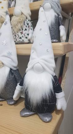 several stuffed gnomes are sitting on shelves with one wearing a white and black hat