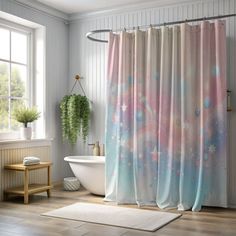 a white bath tub sitting next to a shower curtain in a bathroom under a window