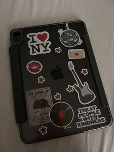 an ipad case with various stickers on it