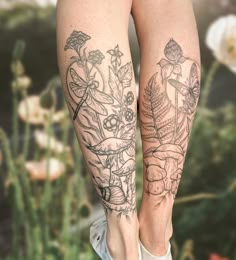 a woman's legs with tattoos and flowers on them