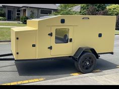 a yellow trailer is parked on the side of the road