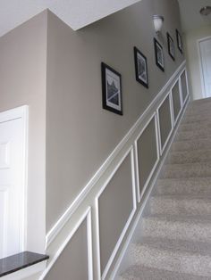 the stairs are lined with pictures and frames