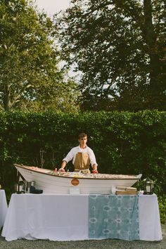 a man sitting in a boat on top of a table