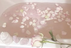 flowers are floating in a bathtub filled with water