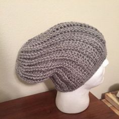 a knitted hat sitting on top of a white mannequin head