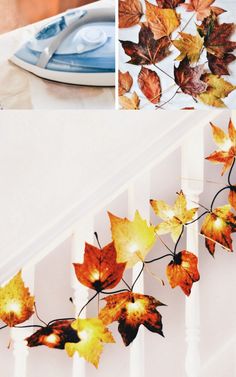 fall leaves are hanging from the railing and on the table, along with plates and utensils