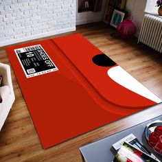 a living room area with a red rug on the floor