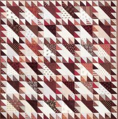 a red and white quilt with many different patterns on it's sides, including the diagonal