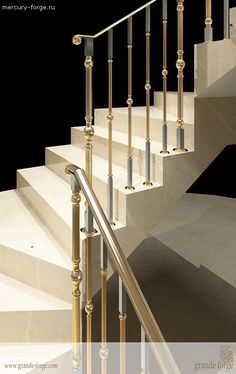 an image of a stair case with glass balustrees and gold handrails