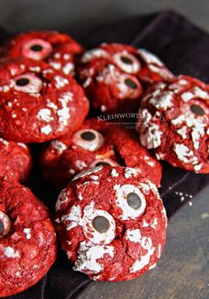 red velvet cookies with googly eyes and white powdered sugar on the top are ready to be eaten