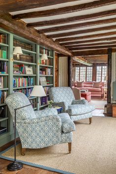 a living room filled with furniture and bookshelves