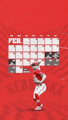 a baseball player is standing in front of a red wall with the scoreboard behind him