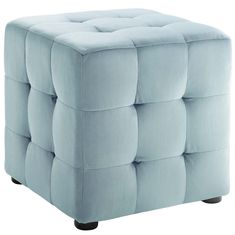 a light blue ottoman that is sitting on top of a white floor and it's upholstered