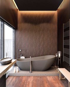 a bathroom with a large bathtub next to a window