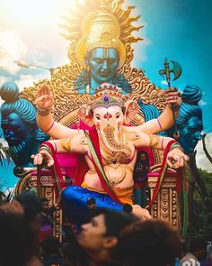 the statue of lord ganesh is surrounded by people