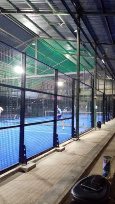 a tennis court with people on it at night