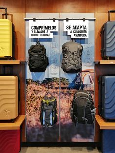 several suitcases and backpacks on display in a store