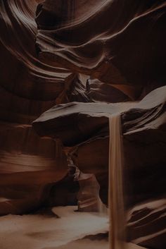 a waterfall in the middle of a canyon