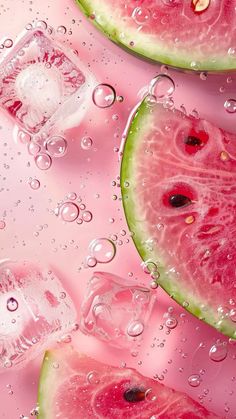 watermelon slices and ice cubes on a pink surface with bubbles around them