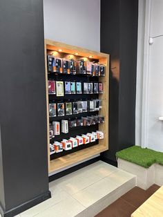 a display case filled with lots of different types of electronic devices next to a bench