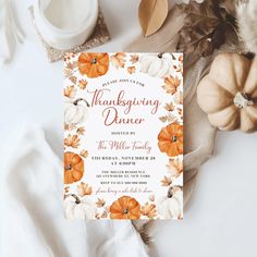 a thanksgiving dinner party with pumpkins and leaves