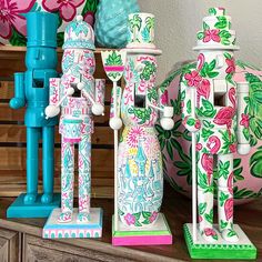 some colorful figurines are sitting on a shelf next to other decorations and vases