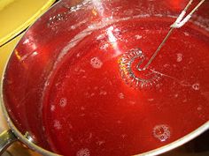 a large metal pot filled with red liquid