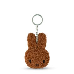 a brown teddy bear keychain with black eyes