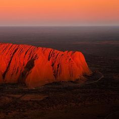 an orange rock formation in the middle of nowhere