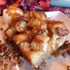 a white plate topped with dessert covered in caramel