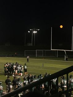 the football team is getting ready to play against each other on the field at night