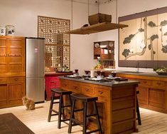 a kitchen with two stools in front of the island and an advertisement on the wall that says, where we love is home