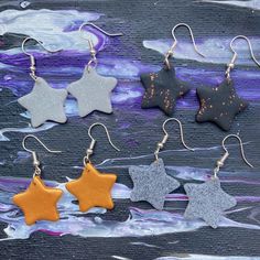 These star/shaped earrings are handmade by me using polymer clay. They are attached to wired earring hooks to allow them to dangle nicely.  The stars are roughly 2.5cm by 2.5cm from their widest areas and dangle nicely from your ears.  These stars are available in Silver, Black, Gold, and Stone. Star Earrings Dangle, Polymer Clay Gifts, Earrings Polymer Clay, Earring Hooks, Small Earrings, Simple Earrings, Earrings Dangle, Star Earrings, Star Shape