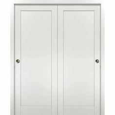 a white closet with two doors on each side