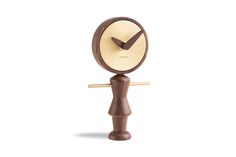 a small wooden clock on a white background