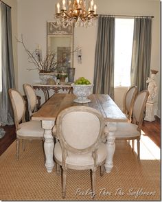 a dining room table and chairs with chandelier